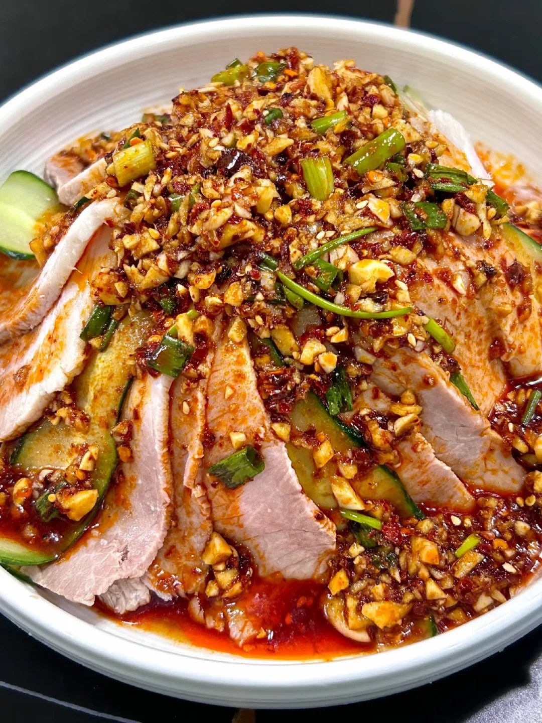 Thin pork slices and cucumber covered with red chili oil and chopped garlic.