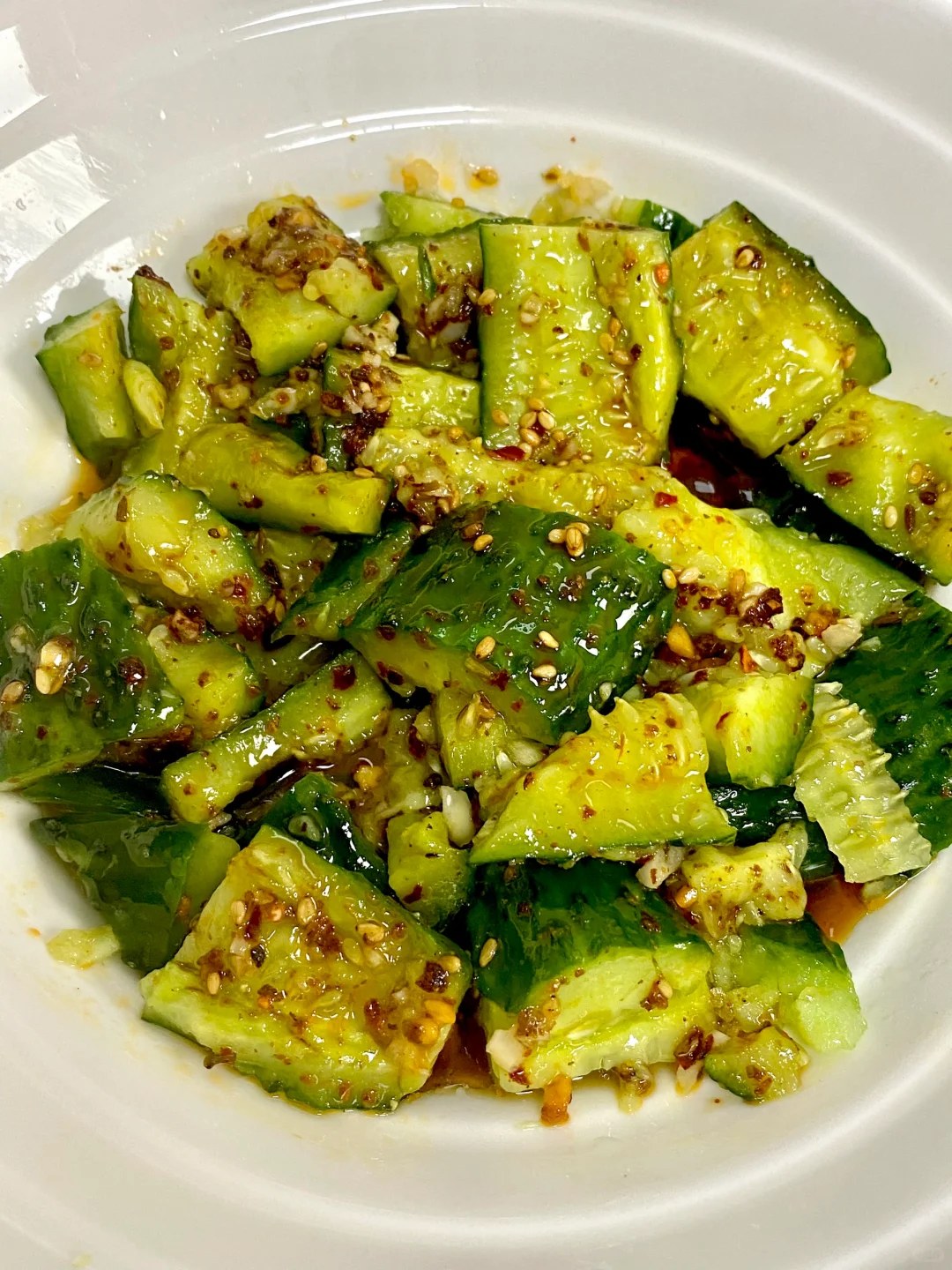 Rough green cucumber chunks dotted with garlic and red chili dressing.